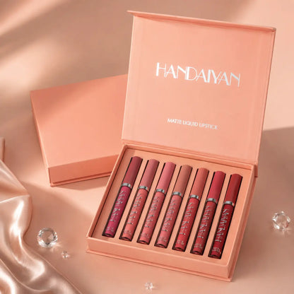 “Premium matte liquid lipstick set displayed in an elegant peach-toned luxury box with six shades ranging from nude to deep rose, presented on a soft satin background, showcasing smooth texture, long-lasting colour and high-end beauty packaging.”
