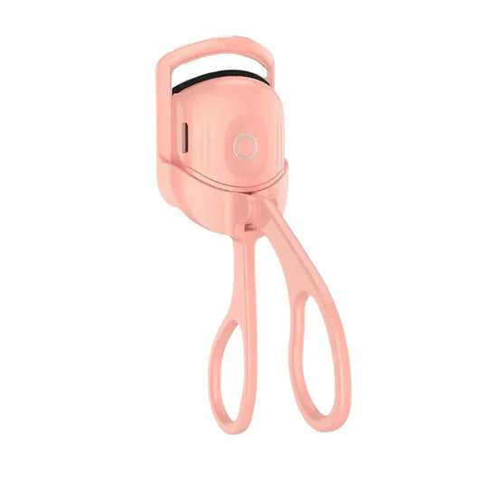 Woman using a heated eyelash curler to create lifted, long-lasting curled lashes with a natural eye-opening effect.